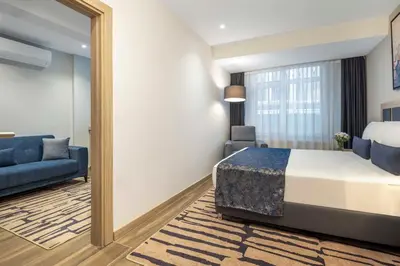 a hotel room with a bed and a mirror at The Capri Hotel Osmanbey in Istanbul