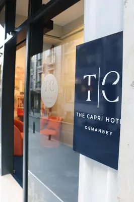 a sign in a window of a carril hotel at The Capri Hotel Osmanbey in Istanbul