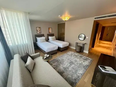 a living room with a couch and a bed at Weingart Suites Hotel in Istanbul