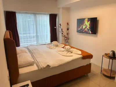 a bed in a room with a window and a bedvisor at Kadıköy Bull Hotel in Istanbul