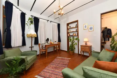 a living room with green furniture and a table at Historical Levantine Flat @Heart of Taksim in Istanbul