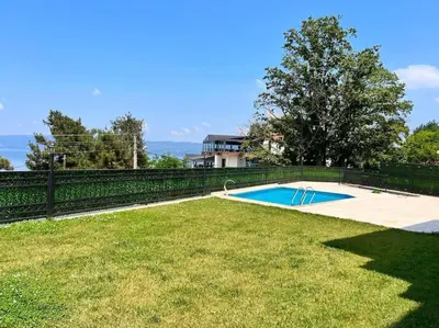 a backyard with a swimming pool and a fence at White Home Sapanca in Sapanca