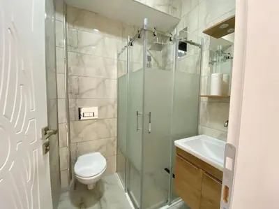 a bathroom with a shower and a toilet and a sink at White Home Sapanca in Sapanca