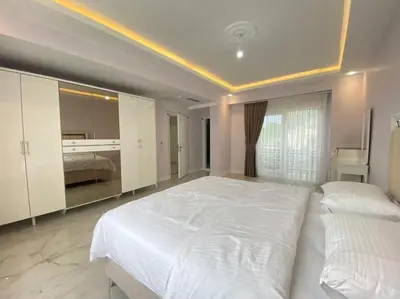 a large bedroom with a large white bed in it at White Home Sapanca in Sapanca