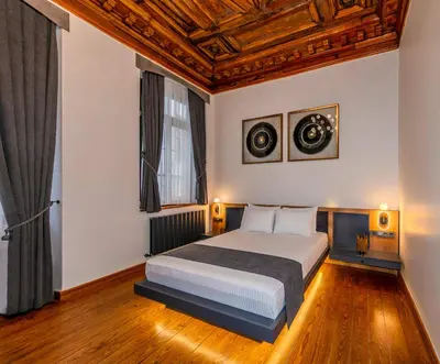 a bedroom with a bed and two paintings on the wall at Elmira Pera Hotel & - Special Class in Istanbul