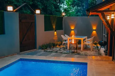 a patio with a table and chairs next to a pool at Alphan House in Sapanca