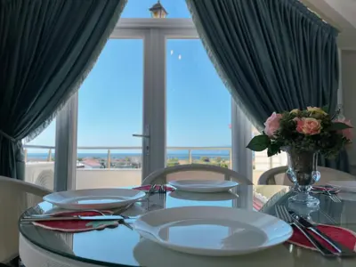 a dining room table with a view of the ocean at Doğanın Kalbindeki Eviniz-7 Kişi in Gemlik