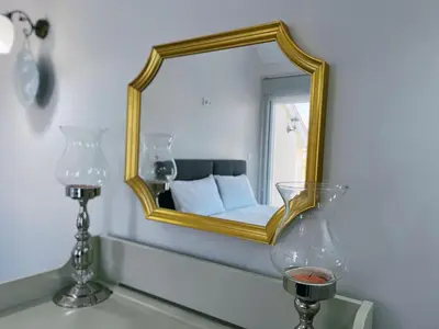 a mirror on a wall with a bed in a room at Doğanın Kalbindeki Eviniz-7 Kişi in Gemlik