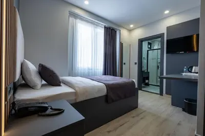 a hotel room with a bed and a sink at FLY POINT AIRPORT HOTEL in Arnavutköy