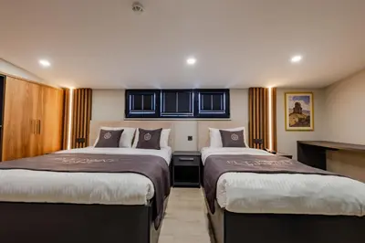 a hotel room with two beds in a room at FLY POINT AIRPORT HOTEL in Arnavutköy