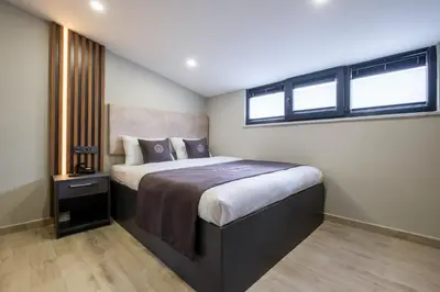 a bedroom with a large bed with a window at FLY POINT AIRPORT HOTEL in Arnavutköy