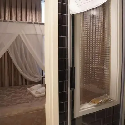 a view of a bedroom with a bed and a window at GALATA KULESİ yakınında geniş 3+1 tarihi daire in Istanbul