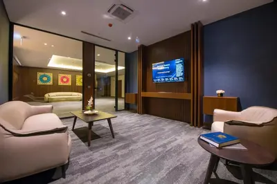 a room with two chairs and a tv on a wall at Crowne Plaza Yalova by IHG in Yalova