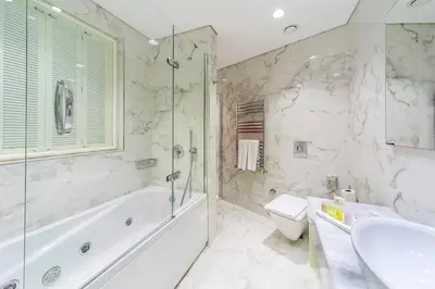 a bathroom with a tub and a toilet and a sink at Hotel Morione & Spa Center in Istanbul
