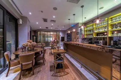 a restaurant with tables and chairs and a bar at Hotel Morione & Spa Center in Istanbul
