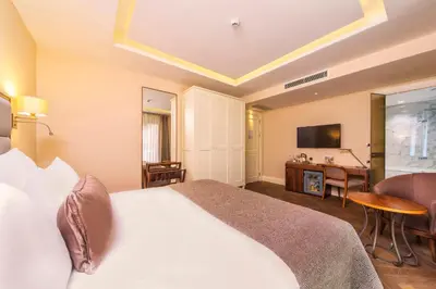 a hotel room with a bed and a desk at Hotel Morione & Spa Center in Istanbul
