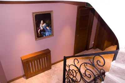 a staircase with a painting of a woman on a wall at Kerimbey Hotel in Gemlik