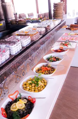 a buffet line with many different plates of food at Kerimbey Hotel in Gemlik