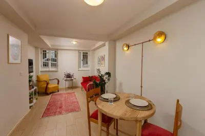 a living room with a wooden table and chairs at Havyar Apartment in Istanbul