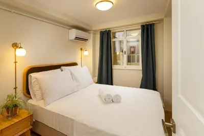 a bedroom with a white bed with two towels on it at Havyar Apartment in Istanbul