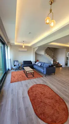 a living room with a couch and a table at فلل التن تاج ALTINTAC villalari in Sapanca