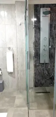 a bathroom with a shower with a glass door at فلل التن تاج ALTINTAC villalari in Sapanca