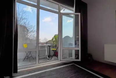 a room with a large window with a view of a patio at Cihangir House in Istanbul
