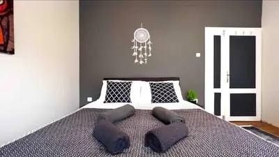a bedroom with a large bed with a clock on the wall at Cihangir House in Istanbul