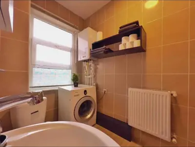 a bathroom with a washing machine and a sink at Cihangir House in Istanbul