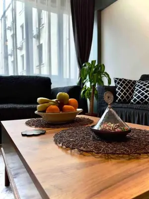 a table with a bowl of fruit on top of it at Cihangir House in Istanbul