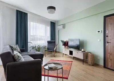 a living room with a couch and a tv at Allegro Apartments Kadıköy in Istanbul