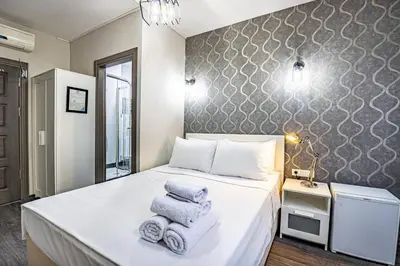 a bedroom with a bed with towels on it at Deluxe Double Room 4 in Istanbul