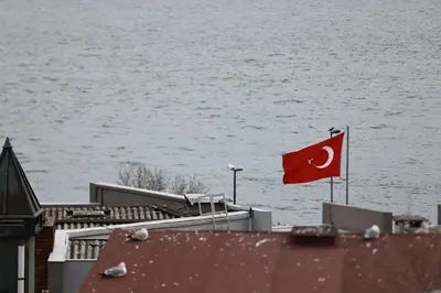 a flag on top of a building next to the water at Deluxe Double Room 4 in Istanbul