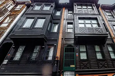 a black apartment building with a green door at Deluxe Double Room 4 in Istanbul