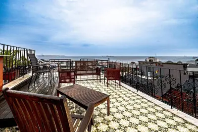 a balcony with chairs and a table and the ocean at Deluxe Double Room 4 in Istanbul