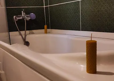 a white bath tub with a candle in it at Дуплекс с видом на Босфор in Istanbul
