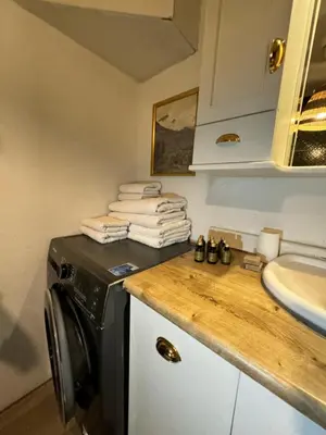 a kitchen with a sink and a washing machine at Дуплекс с видом на Босфор in Istanbul
