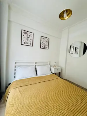a bedroom with a large bed with a gold blanket at Дуплекс с видом на Босфор in Istanbul