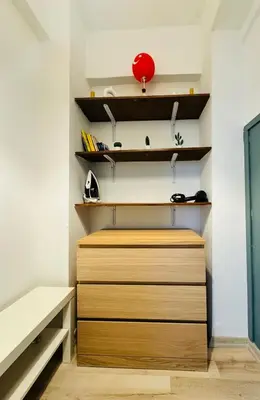a closet with wooden shelves and aabinet at Дуплекс с видом на Босфор in Istanbul