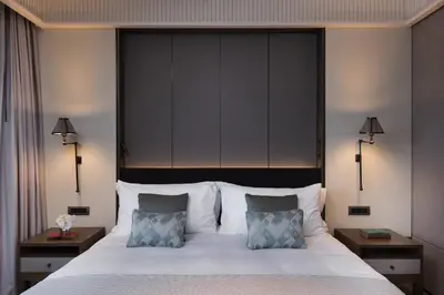 a bedroom with a large bed with two pillows at Princes' Palace Resort, Buyukada - Member of The Leading Hotels of the World in Adalar