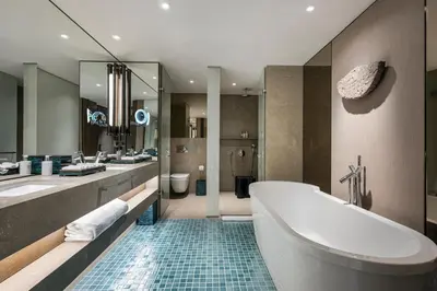 a bathroom with two sinks and a tub and two toilets at Princes' Palace Resort, Buyukada - Member of The Leading Hotels of the World in Adalar