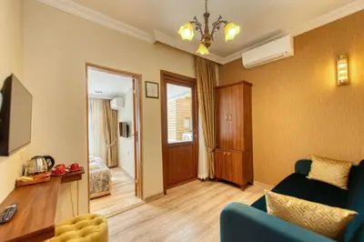 a living room with a blue couch and a television at Brown 2 Mansion Oldcity in Istanbul