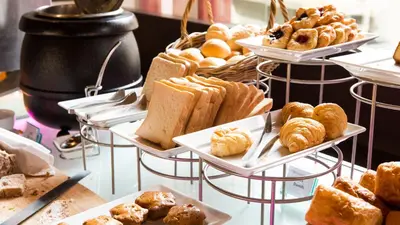 a display of various pastries and breads on trays at Crowne Plaza Istanbul Oryapark by IHG in Istanbul