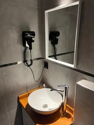 a bathroom with a sink and a mirror at Meet İstanbul Hotel Kadikoy in Istanbul