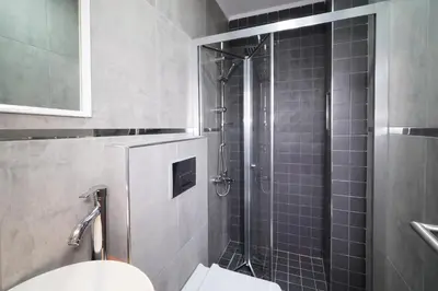 a bathroom with a shower with a toilet and a sink at Meet İstanbul Hotel Kadikoy in Istanbul