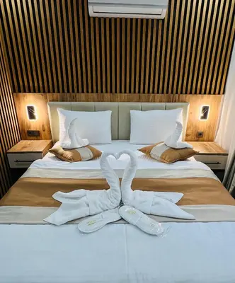 two swans made out of towels sitting on a bed at Ninova Boutique Hotel in Istanbul