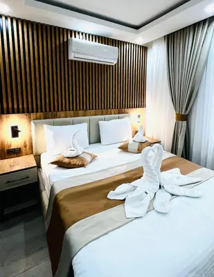 a hotel room with two beds with towels on them at Ninova Boutique Hotel in Istanbul
