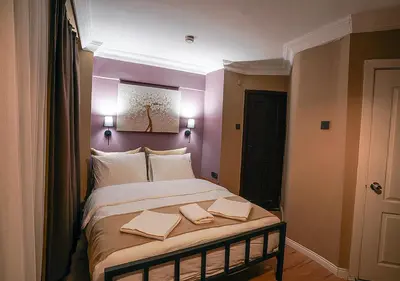 a bedroom with a large bed with two towels on it at THE BEYBÛN HOTEL İstiklal Street Taksim in Istanbul