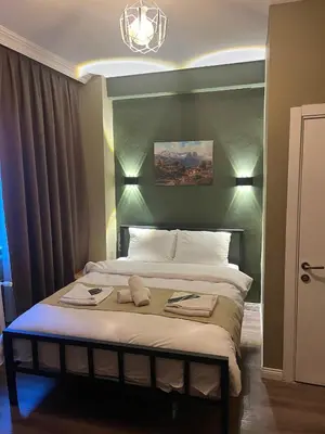 a bedroom with a large bed with a chandelier at THE BEYBÛN HOTEL İstiklal Street Taksim in Istanbul