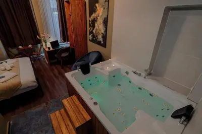 a bathroom with a tub filled with green water at THE BEYBÛN HOTEL İstiklal Street Taksim in Istanbul